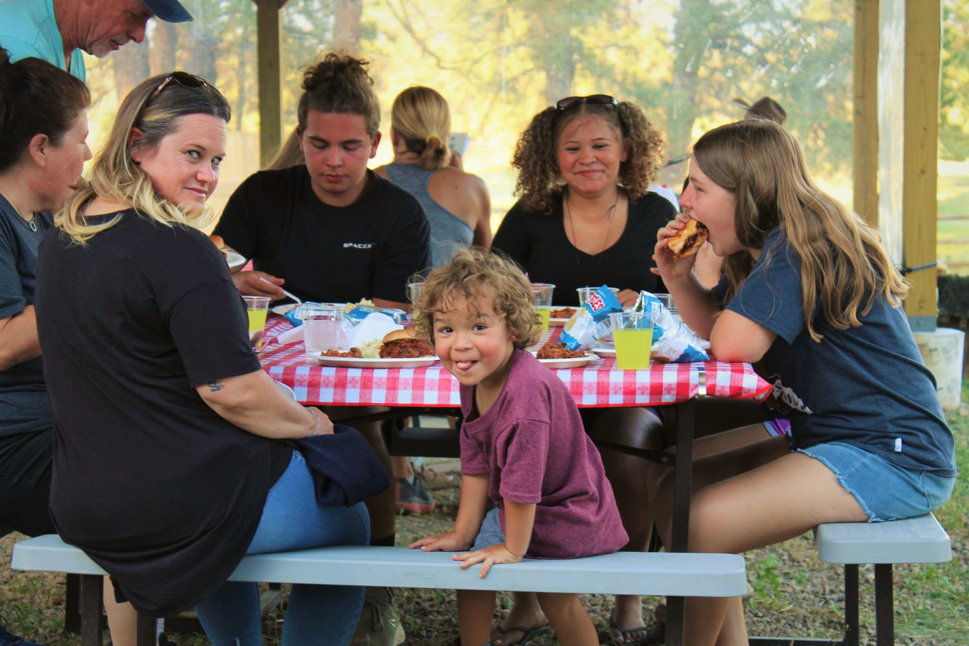 Cowboy playing a guitar and singing a song around a campfire