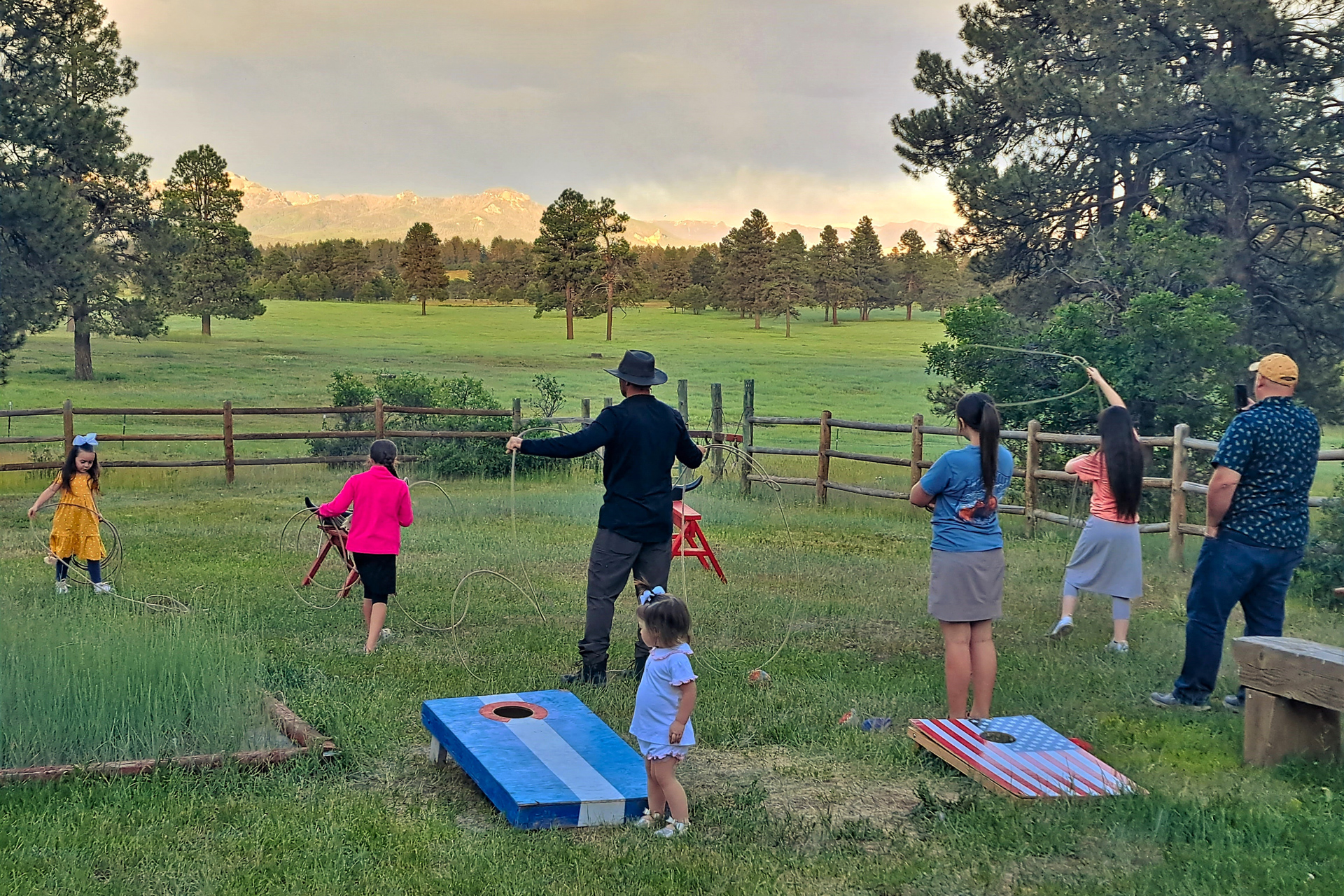 A group of people throw ropes at pretend cows